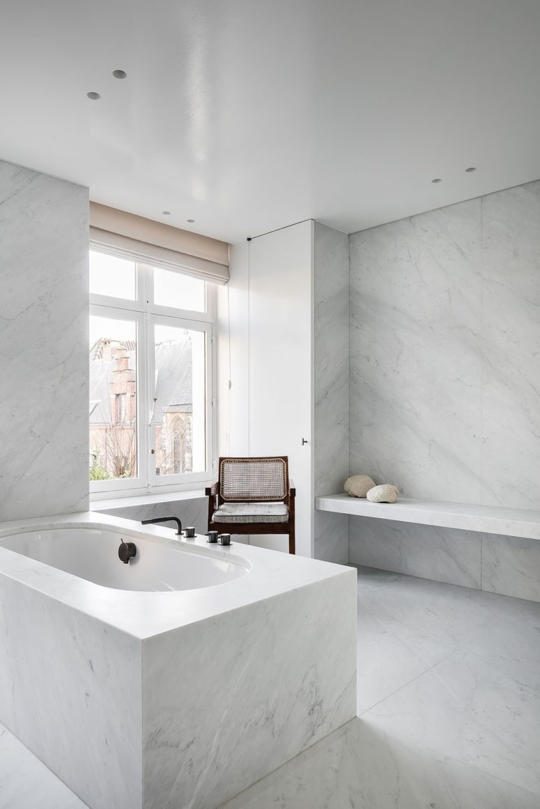 luxurious marble bathroom The bathroom is clad with white marble, it's filled with natural light through the window and there's much space