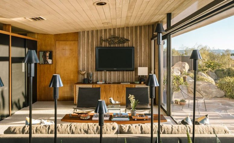 hidden living room storage There's a creative floor lamp combo and all the storage is hidden inside black paneled wardrobes