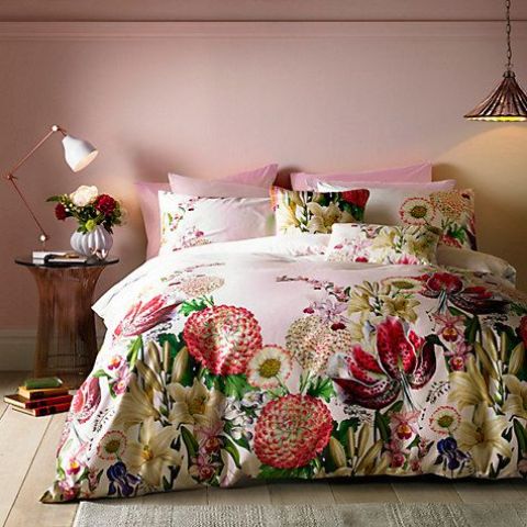 pink bedding with oversized flowers in yellow and red makes a bold trendy statement