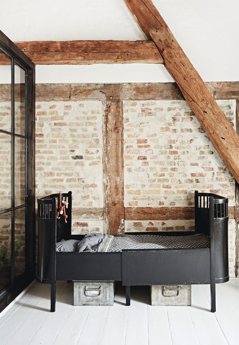 The kid's room is a boy's space, there are beams and brick walls and a vintage metal bed, a metal box under the bed is used for storage The kid's room is a boy's space, there are beams and brick walls and a vintage metal bed, a metal box under the bed is used for storage