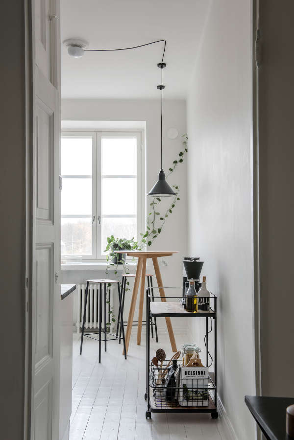 bar cart for a kitchen The kitchen is all-white, with tall stools, greenery and a metal bar cart for an industrial feel