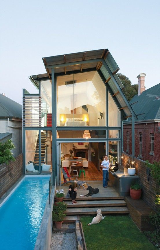 a leveled backyard with a lawn and a narrow pool uses the whole space effectively