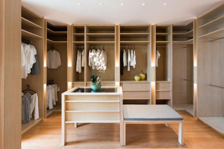 cool closet design The closet is pure elegance with light-colored wooden wardrobes and an accessory chest, nothing unnecessary here