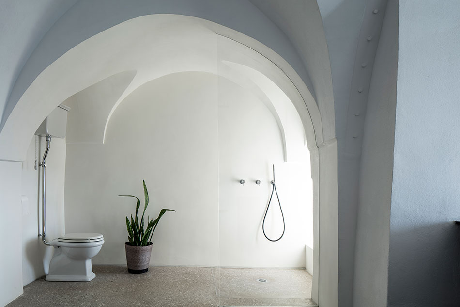 The bathroom is also minimalist, with a seamless glass shower