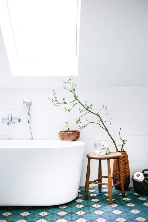 a colorful touch is given to the bathroom with bold mosaic floors