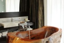 14 a rough carved stone bathroom makes a bold statement in this elegant marble bathroom