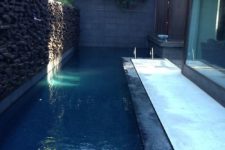 15 a narrow pool that goes along the whole house and keeps privacy with a stone wall