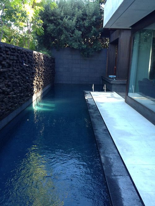 15 a narrow pool that goes along the whole house and keeps privacy with a stone wall