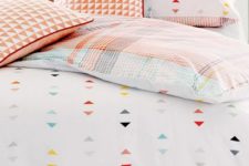 15 pastel checked bedding with colorful triangle prints on the duver and some pillowcases