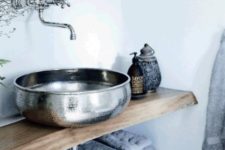 21 a metal sink and matching hardware contrast with wood