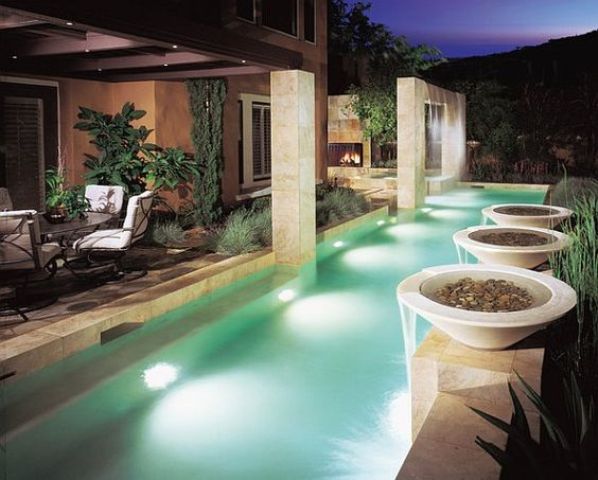 an outdoor dining space and a narrow pool lining up the whole space