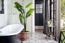 25 a palm tree in a woven pot enlivens a black and white bathroom