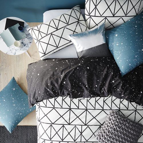 graphic black and white bedding and blue and black speckled touches