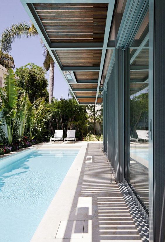 long lap pool along the whole side of the house, it's clad with stone-like concrete