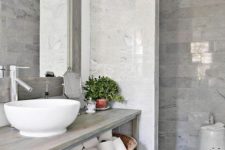 28 a grey bathroom is enlivened with a single potted plant