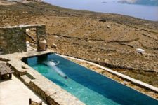 30 nature-inspired stone clad narrow pool with a view to the desert and sea