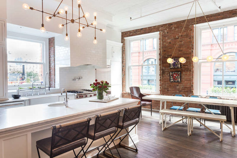 kitchen with tiles The kitchen is rather traditional, clad with white tiles and there is white cabinetry, a large kitchen island is covered with white marble