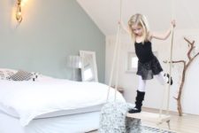 02 a swing in a serene and light-colored girl’s room is a storage piece and a play piece in one