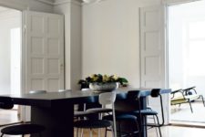 03 The dining space features a black modern dining set and a cool mid-century modern lamp over it, the accents are white on black