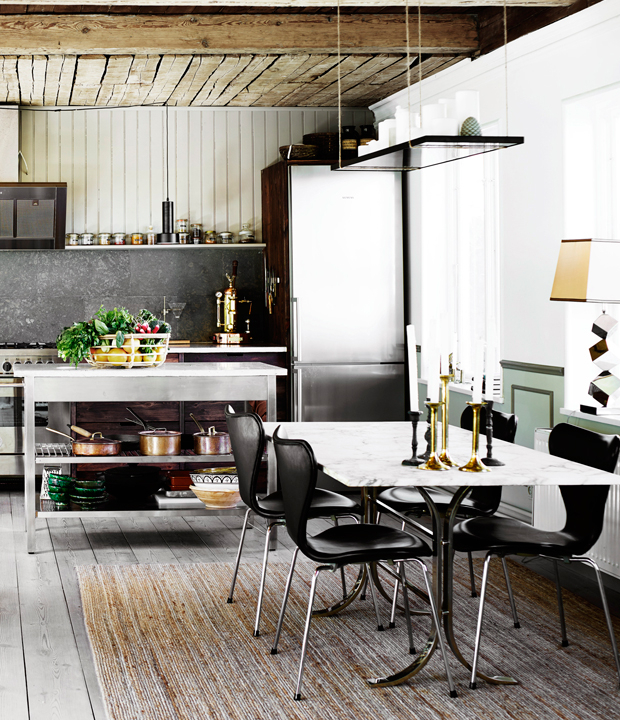 The dining space is defined by a marble dining table and a hanging framed lighting