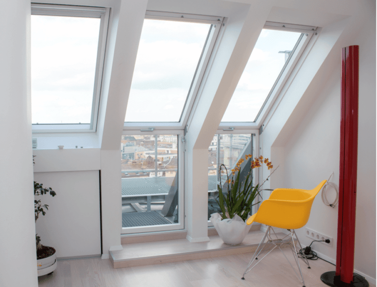 There are large windows everywhere to fill the spaces with natural light and some colorful touches to cheer up the interior