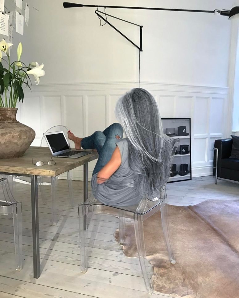 The dining space can be used as a home office, and I love a glass cabinet with tall hats and boots on display, so glam and unique