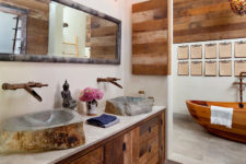 08 The bathroom features much weathered wood, a wodoen bathtub and stone sinks that catch an eye