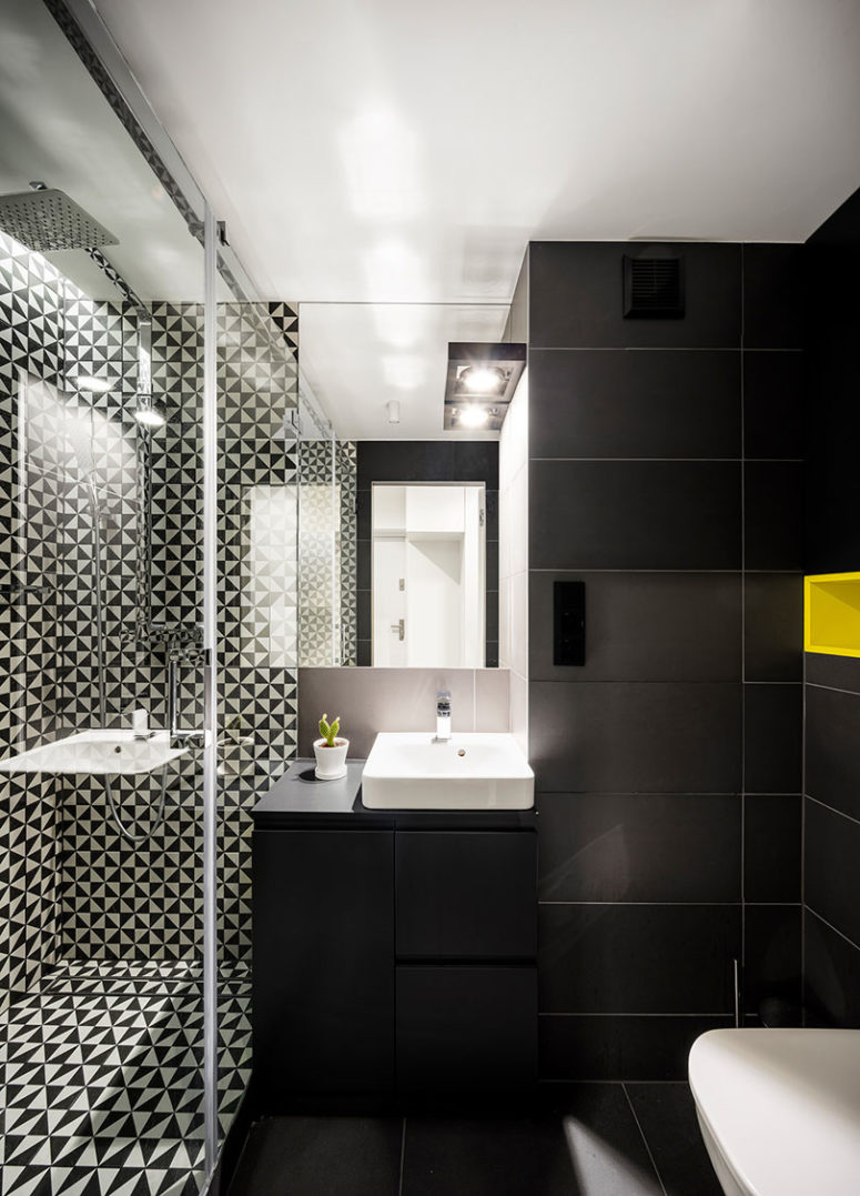 The bathroom is done in matte black and with graphic geo print tiles in the shower, it looks modern and very chic