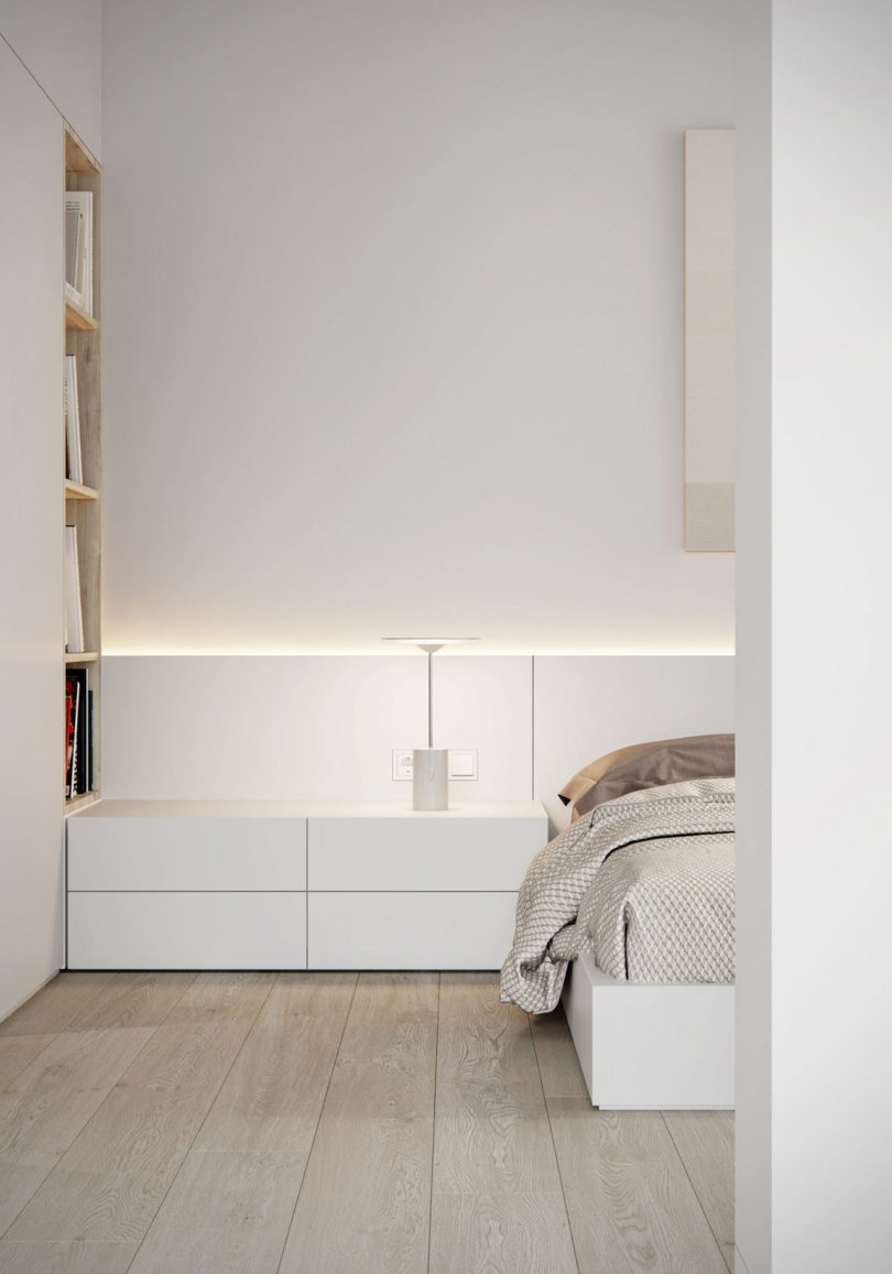 The bedroom is done in the same style, with sleek white furniture and several layers of light for maximal comfort