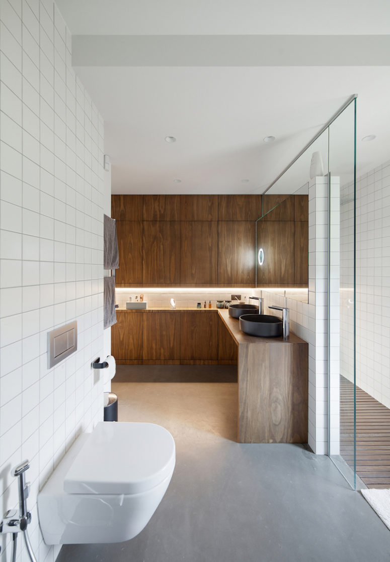The walls are white, the floor is gray and the furniture is made of wood, adding warmth to the space The walls are white, the floor is gray and the furniture is made of wood, adding warmth to the space