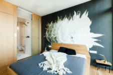 10 The master bedroom features an oversized floral mural on the headboard wall and a door to the bathroom