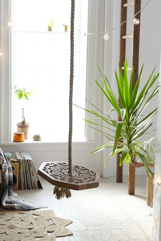 a wood carved indoor swing will be a part of your boho space and will make it more eye-catchy