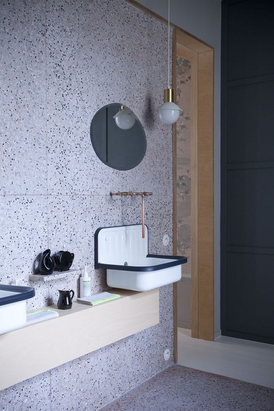 black and white dotted terrazzo and retro lamps and fixtures look unusual together