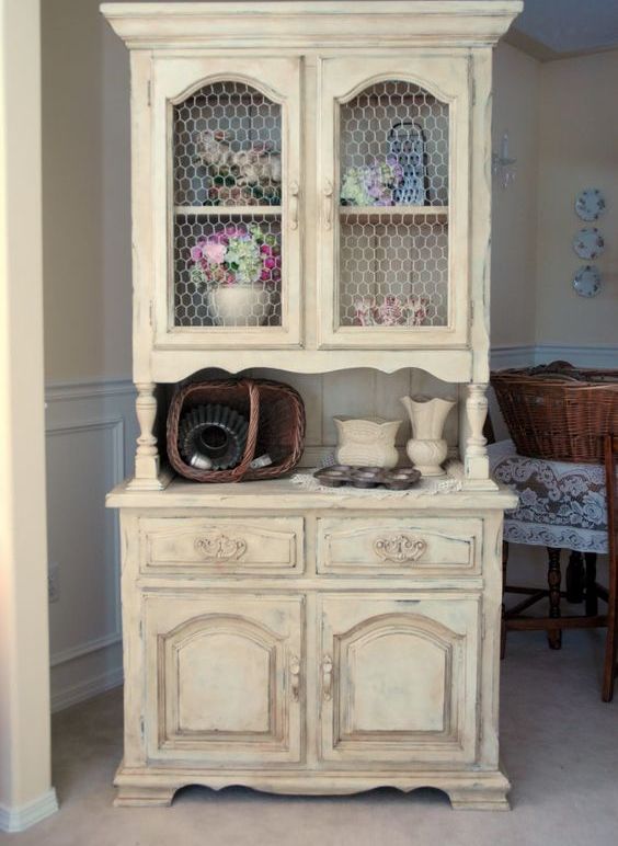 shabby chic buttermilk cupboard with chicken wire on the former glass compartments