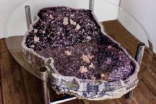 23 a purple and pink geode coffee table on metal legs and with a glass tabletop