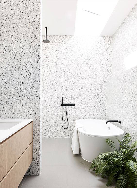 lighter terrazzo in the shower and bathtub zone and darker in the sink zone