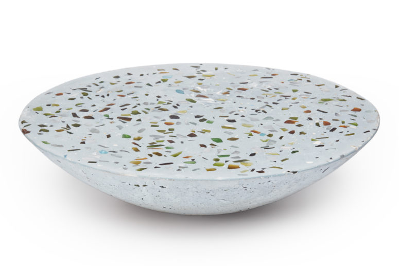 a bowl-shaped terrazzo coffee table with colorful inserts is amazing both for indoors and outdoors