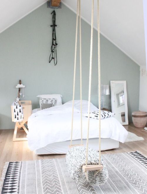 Scandinavian bedroom in black and white and a swing that can be used as a stoage unit