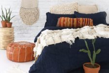 34 textural navy bedding with white crochet pillows and a fringe blanket