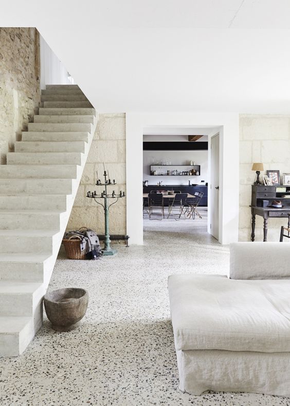 white terrazzo floors are a durable and cool solution that fits this rustic Provence space