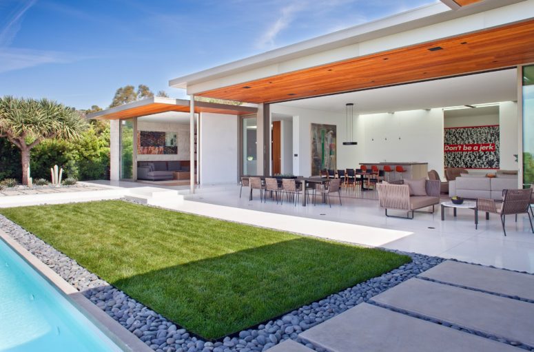 This mid century modern house is a home to a large wall art collection, it's designed in the best traditions of modernism and mid century decor
