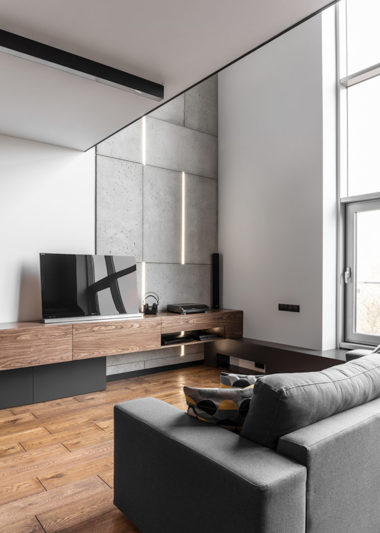 Grey, black and white with a wide use of warm colroed natural wood were used for decorating this bachelor's pad