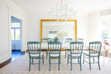 02 The dining room is spruced up with vintage blue chairs and an oversized gilded frame mirror to make it refined