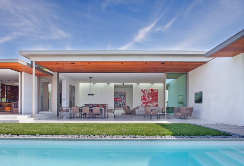 The house consists of several wings, all of them can be easily opened to outdoors, there's an inner courtyard and a swimming pool
