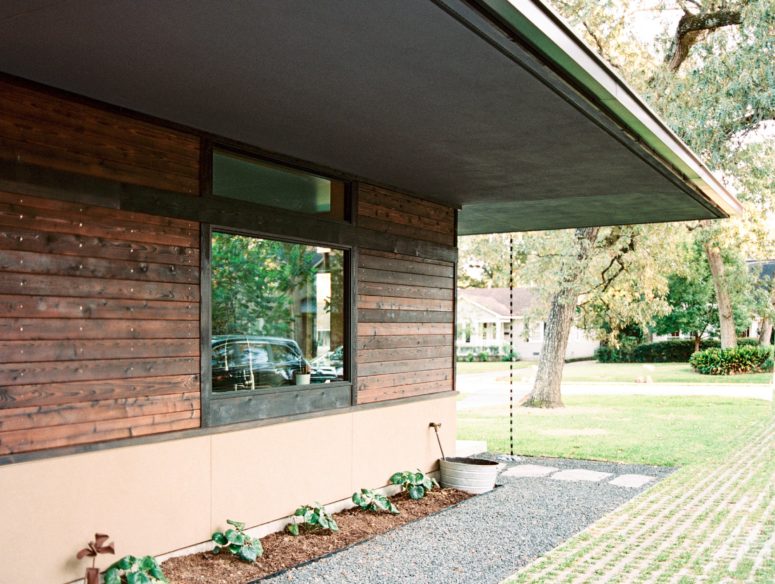 The house is clad with stained wood, and a traditional Japanese technique was used to make it