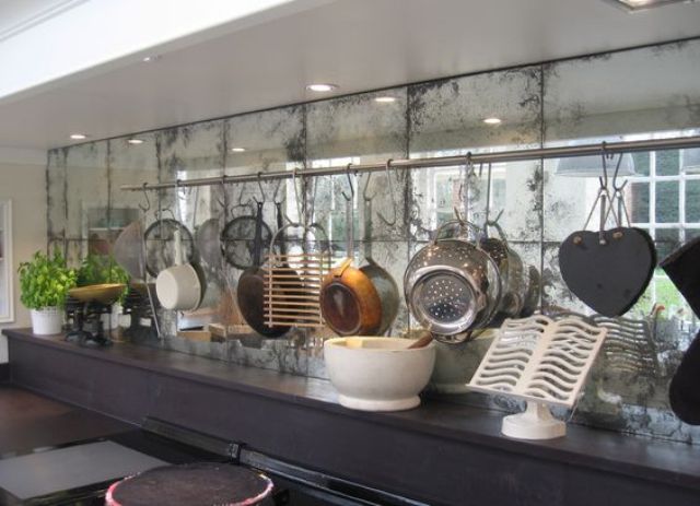 a kitchen backsplash of faded mirror looks nice with a dark countertop