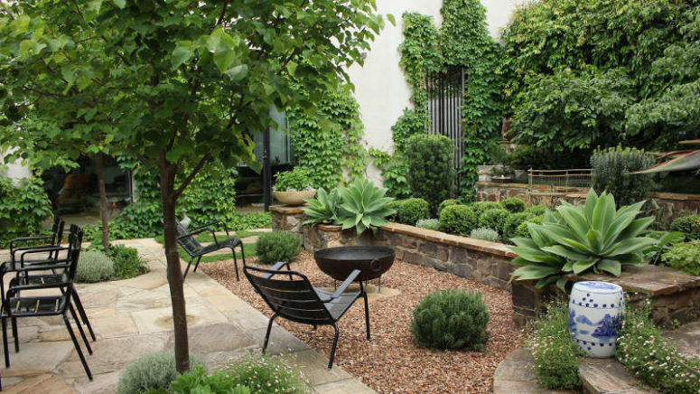 The furniture is black not to distract attention from the gorgeous lush greenery
