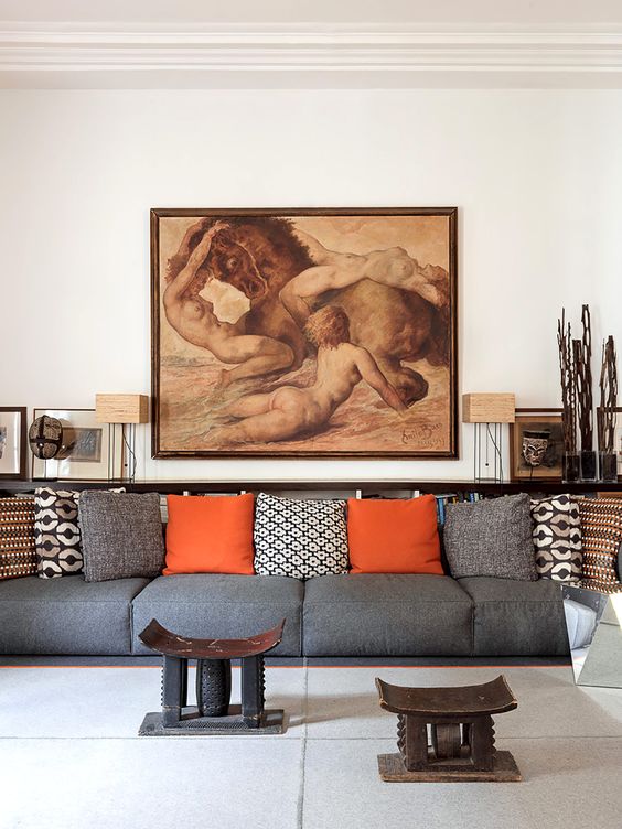This is the second living room with an oversized grey sofa, Asia inspired artworks and furniture and a bold piece of art that makes a statement This is the second living room with an oversized grey sofa, Asia-inspired artworks and furniture and a bold piece of art that makes a statement