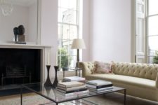 03 a black framed glass coffee table makes this vintage living room more modern