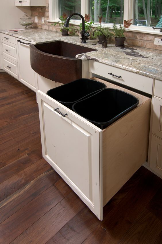 a large pull out drawer with two trash cans will fit your needs
